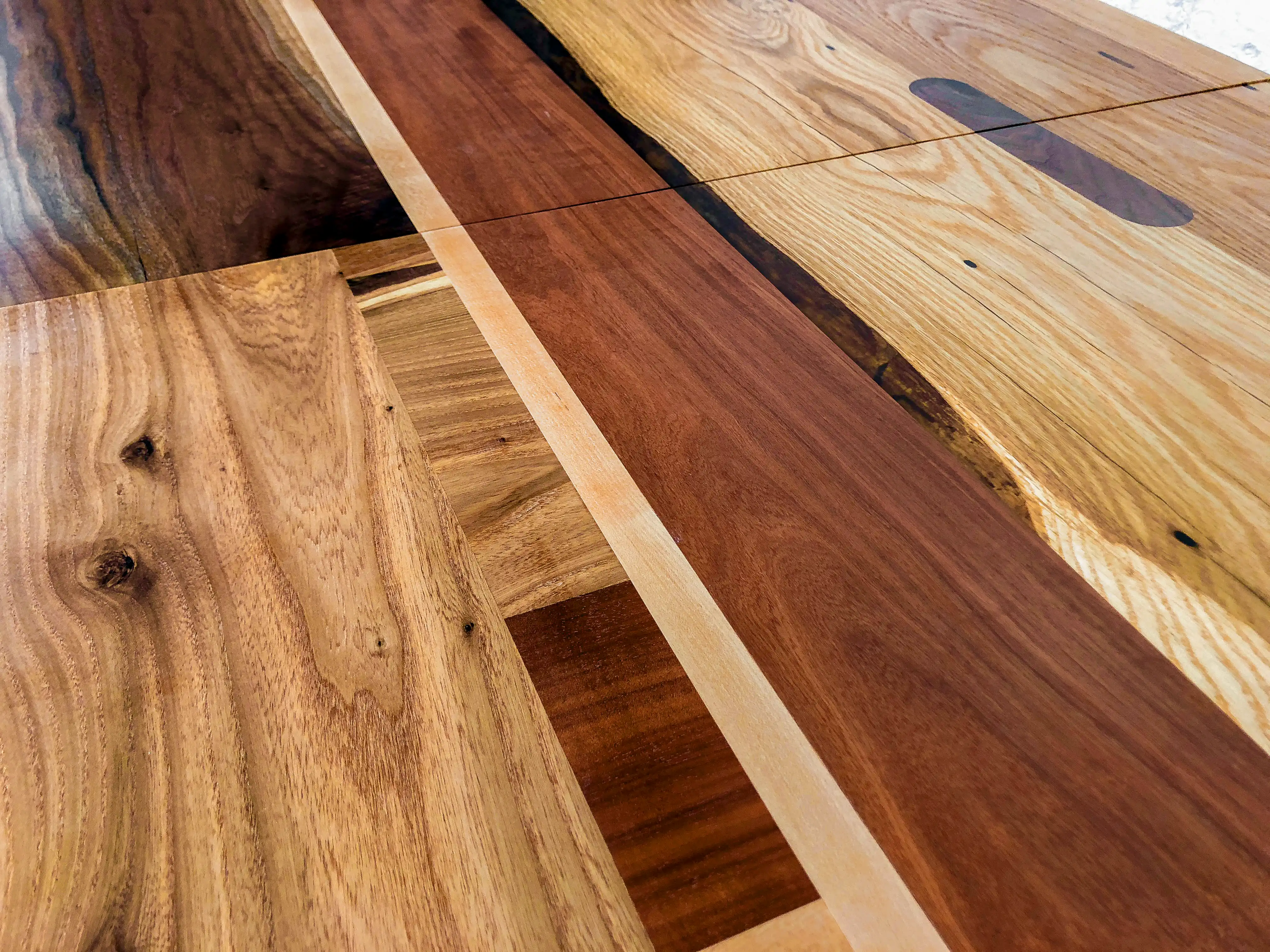 Detail image of custom dining room table. Walnut, oak, maple, sycamore and elm